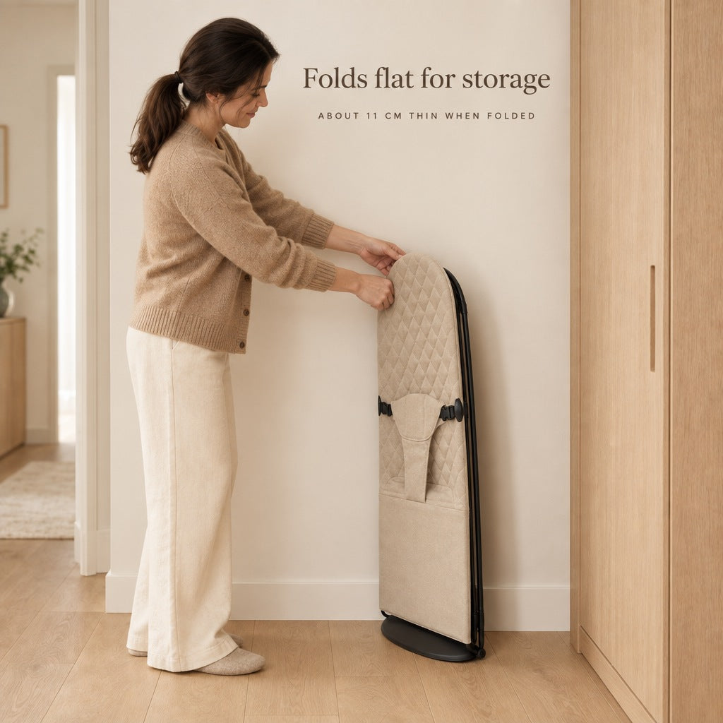 Baby bouncer folded flat and stored upright beside a wardrobe