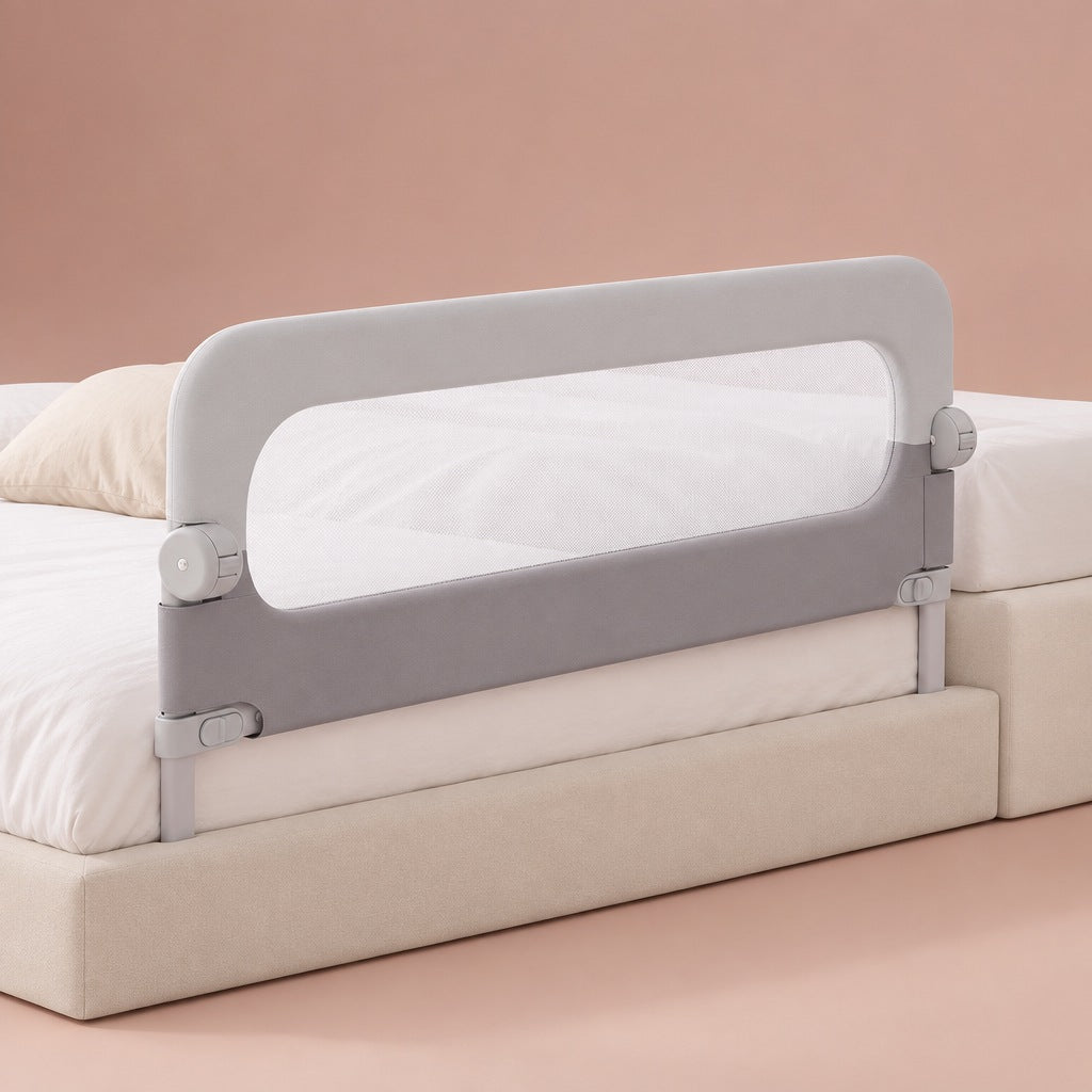 Two-tone grey fold-down bed rail with mesh window mounted on a child's bed