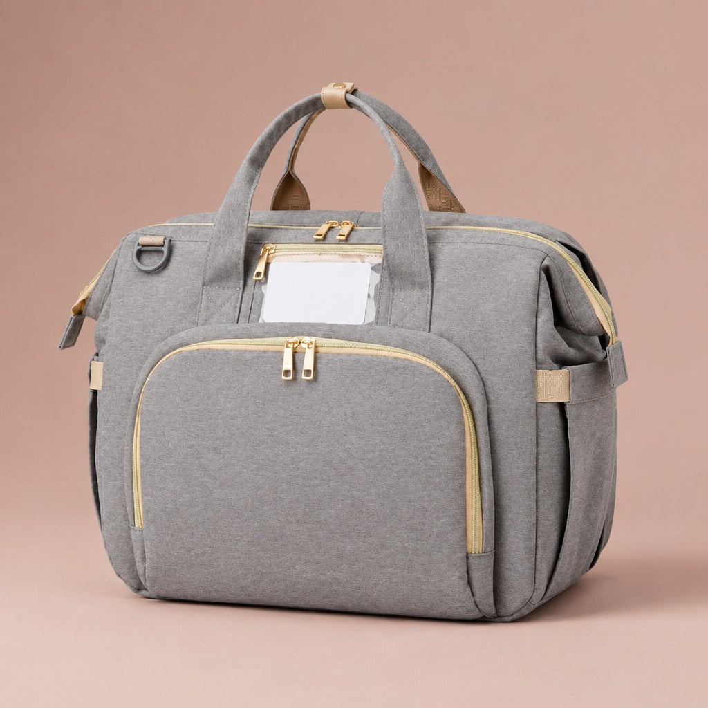 Baby changing bag with fold-out bed in light grey with gold-tone zips