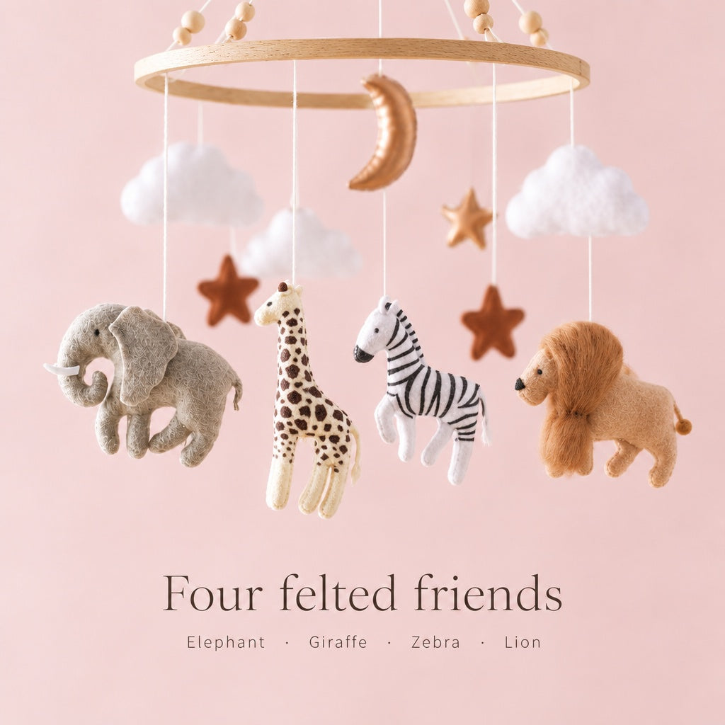 Four felted animals of the crib mobile: elephant, giraffe, zebra and lion