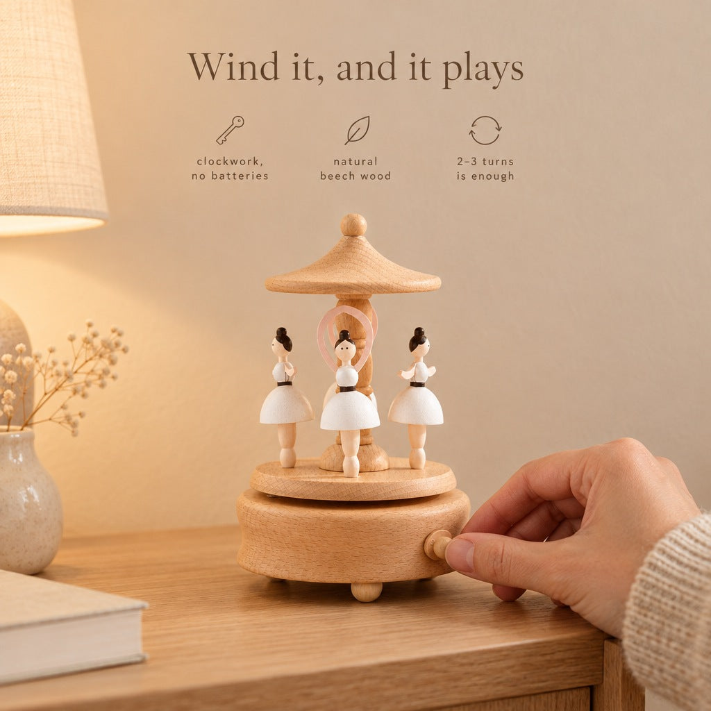 Hand winding the ballerina music box on a bedside table - clockwork, no batteries, natural beech wood