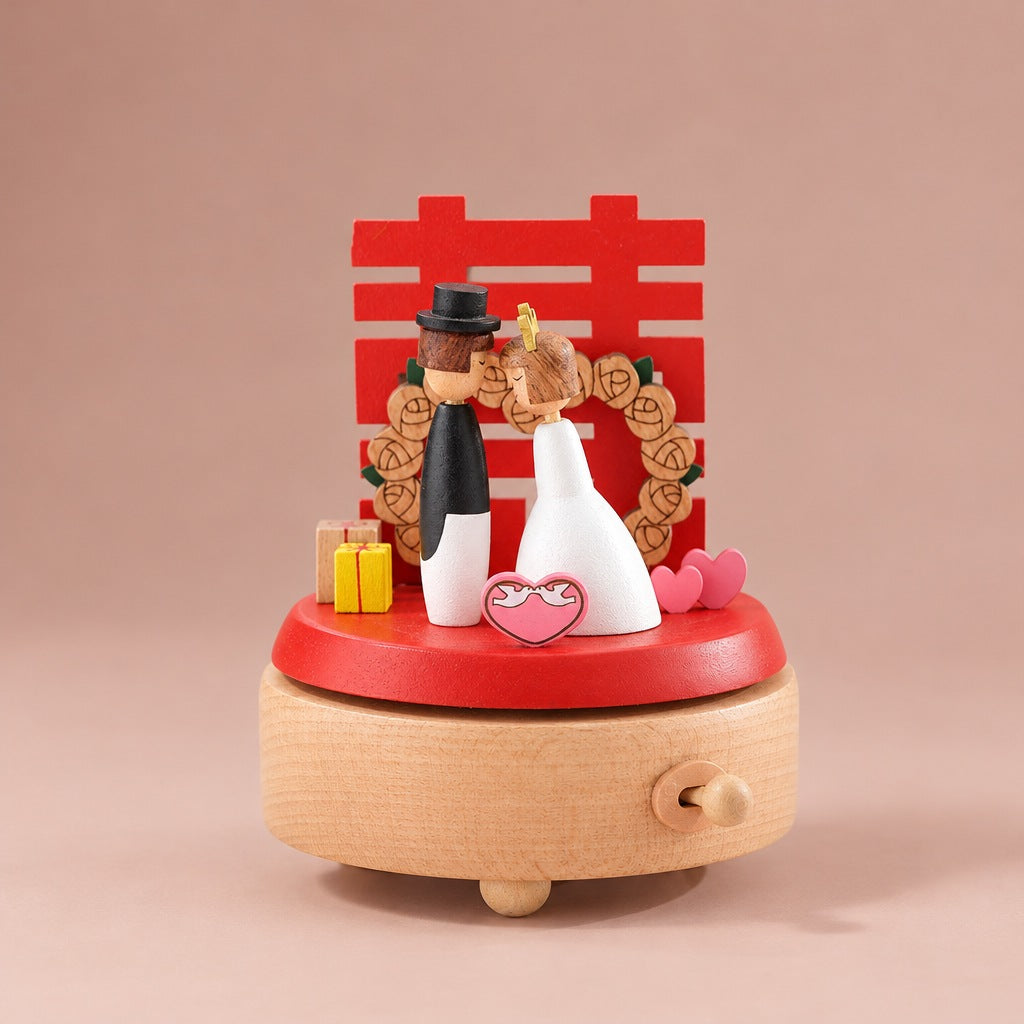 Wooden wedding music box with bride and groom on a red stand