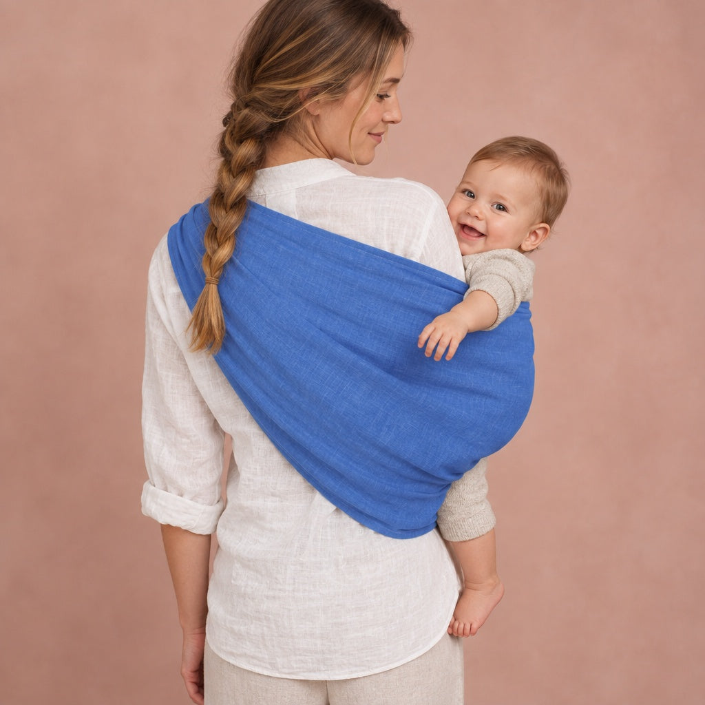 Back view of a blue baby ring sling spread across a mother's back, baby on her hip
