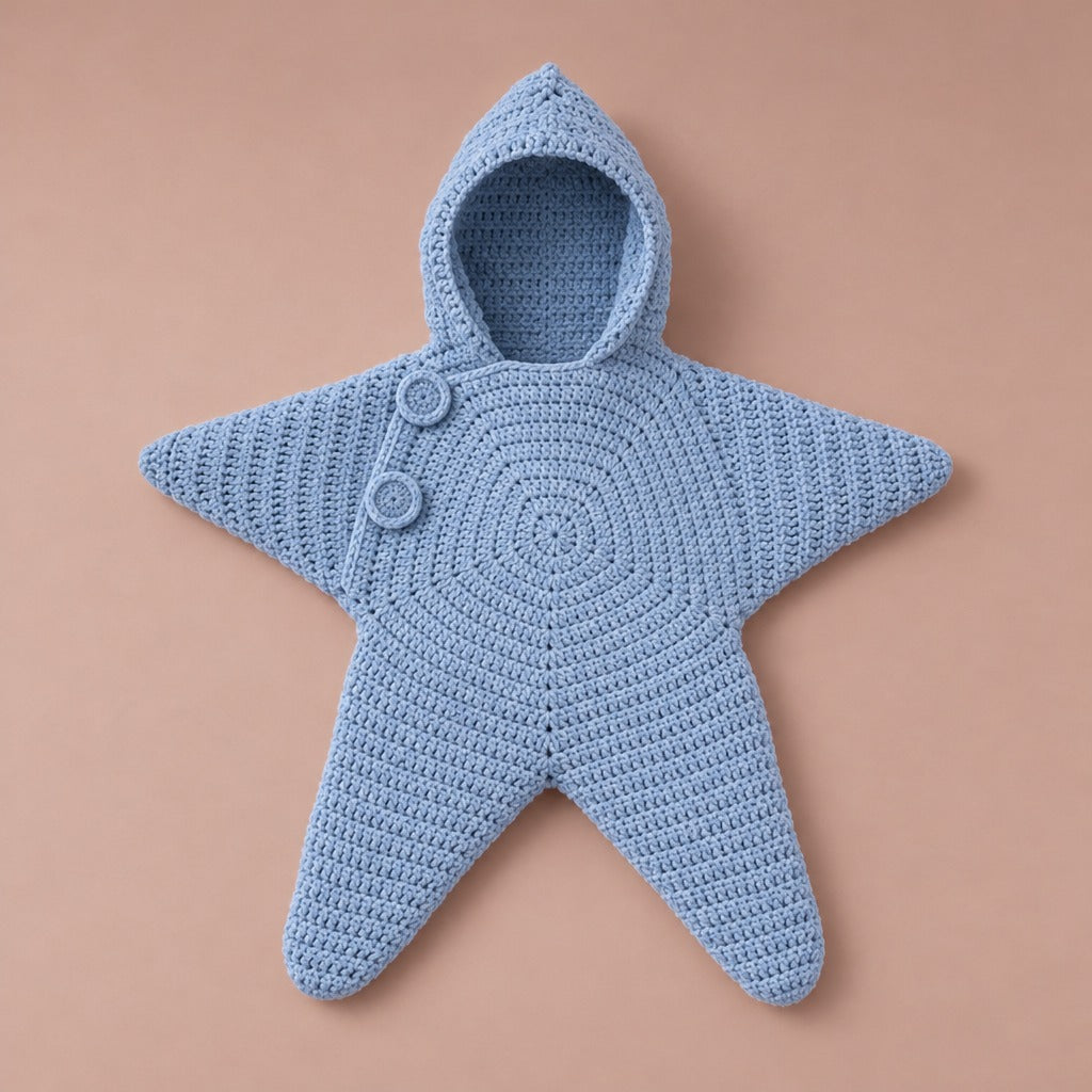 Blue crochet star suit with hood and two buttons, laid flat