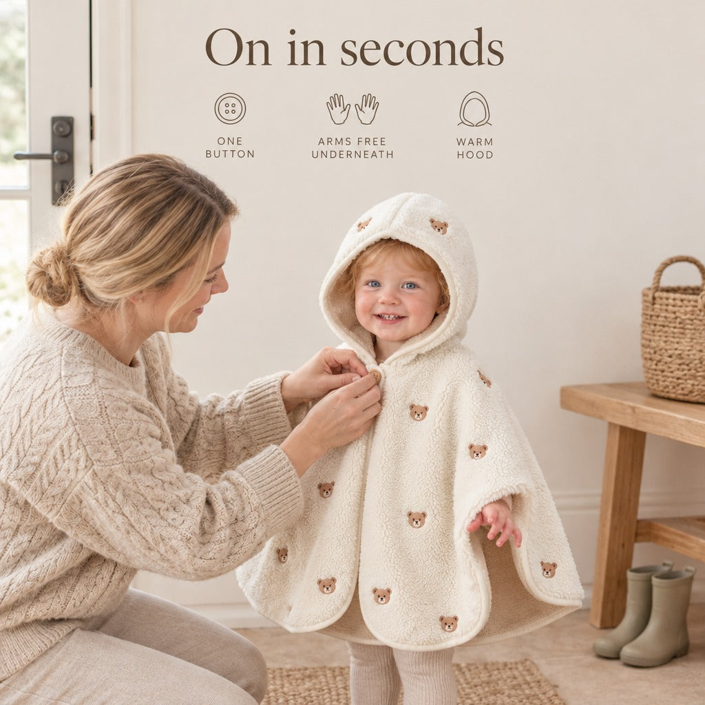 Mother buttoning The Teddy Mantle on her toddler — On in seconds