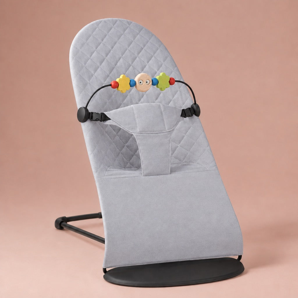 Light grey quilted cotton baby bouncer with wooden toy bar and black frame