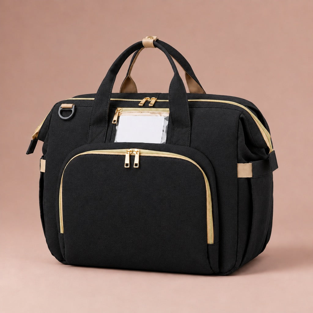 Baby changing bag with fold-out bed in black with gold-tone zips