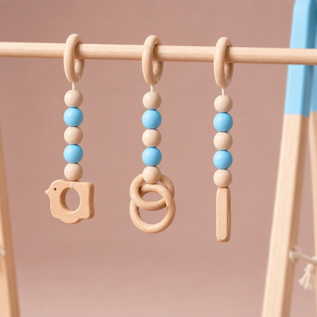 Close-up of the three hanging toys with wooden and blue beads